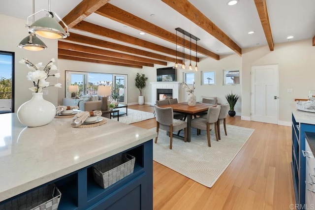 2264 Soto St, San Diego, CA 92107 - dining area with a glass covered fireplace, beamed ceiling, light wood-type flooring, recessed lighting, and baseboards