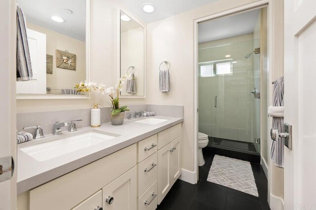 2264 Soto St, San Diego, CA 92107 - bathroom featuring double vanity, toilet, a shower stall, tile patterned flooring, and recessed lighting