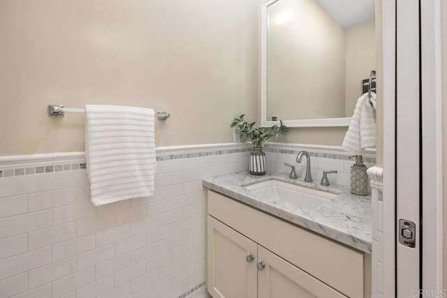 2264 Soto St, San Diego, CA 92107 - bathroom featuring vanity, a wainscoted wall, and tile walls