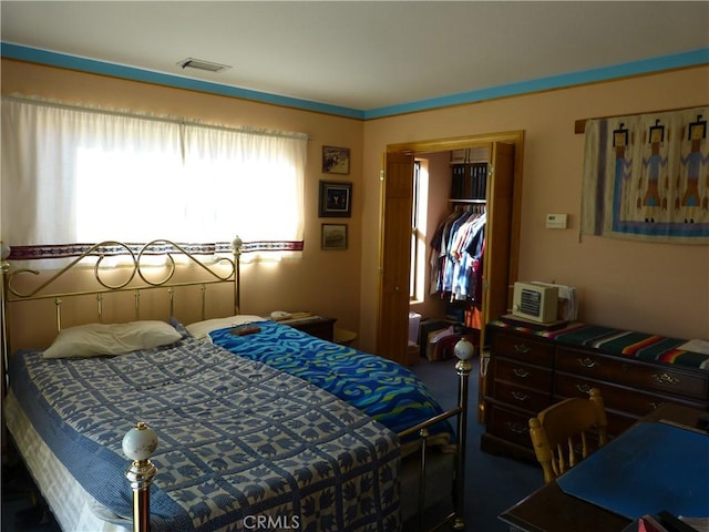 bedroom with a closet and visible vents