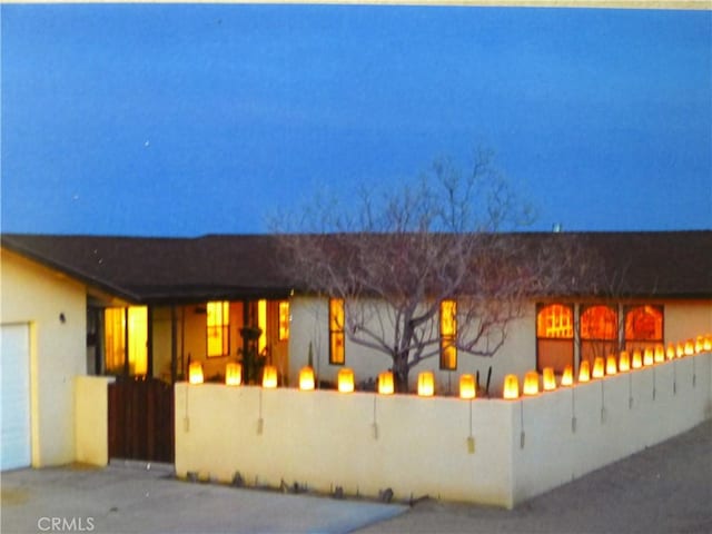 exterior space featuring stucco siding and a fenced front yard