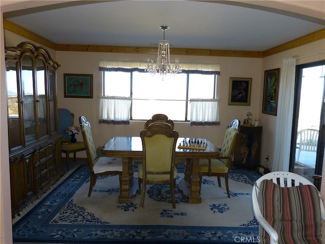 dining area with a wealth of natural light and a notable chandelier