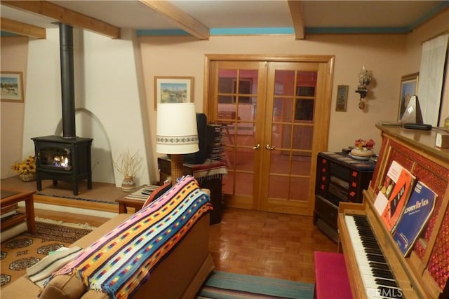 living room with french doors, beam ceiling, and a wood stove