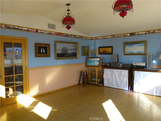 miscellaneous room featuring baseboards, lofted ceiling, and visible vents