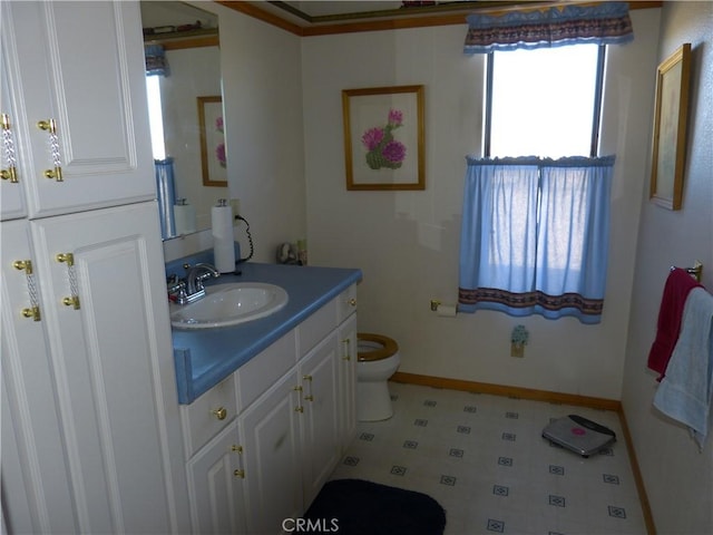 bathroom with baseboards, toilet, tile patterned floors, and vanity