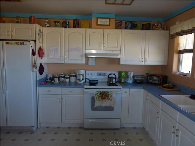kitchen featuring white appliances, white cabinets, and under cabinet range hood
