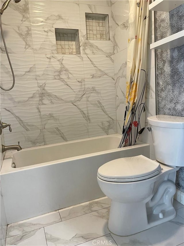 bathroom with shower / bath combination with curtain, marble finish floor, and toilet