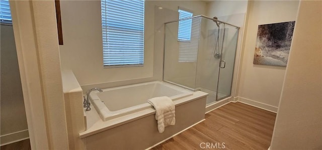 5232 Las Palmas Way, Chino, CA 91710 - bathroom with wood finished floors, a shower stall, a bath, and baseboards