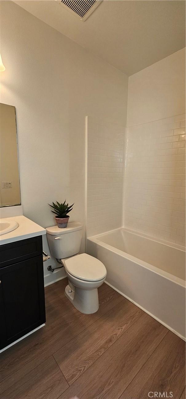 5232 Las Palmas Way, Chino, CA 91710 - bathroom featuring toilet, wood finished floors, and vanity