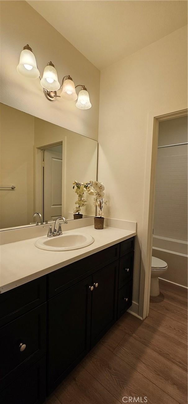 5232 Las Palmas Way, Chino, CA 91710 - full bathroom featuring wood finished floors, vanity, toilet, and a tub