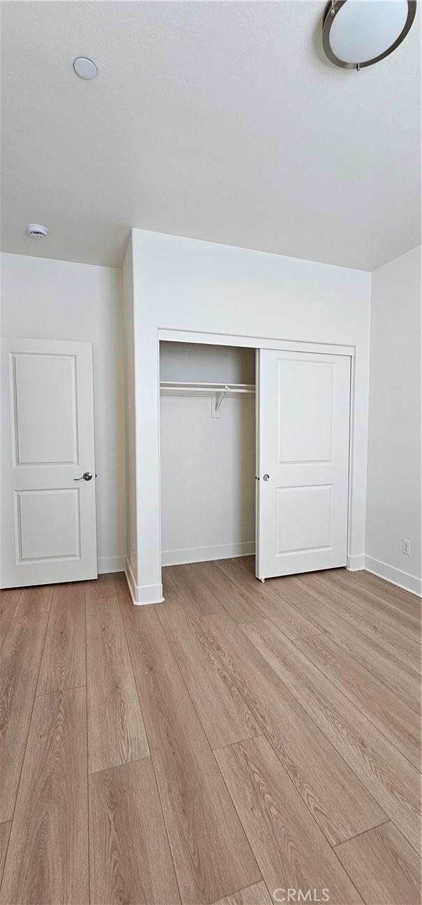 5232 Las Palmas Way, Chino, CA 91710 - unfurnished bedroom featuring light wood-style flooring, baseboards, and a closet