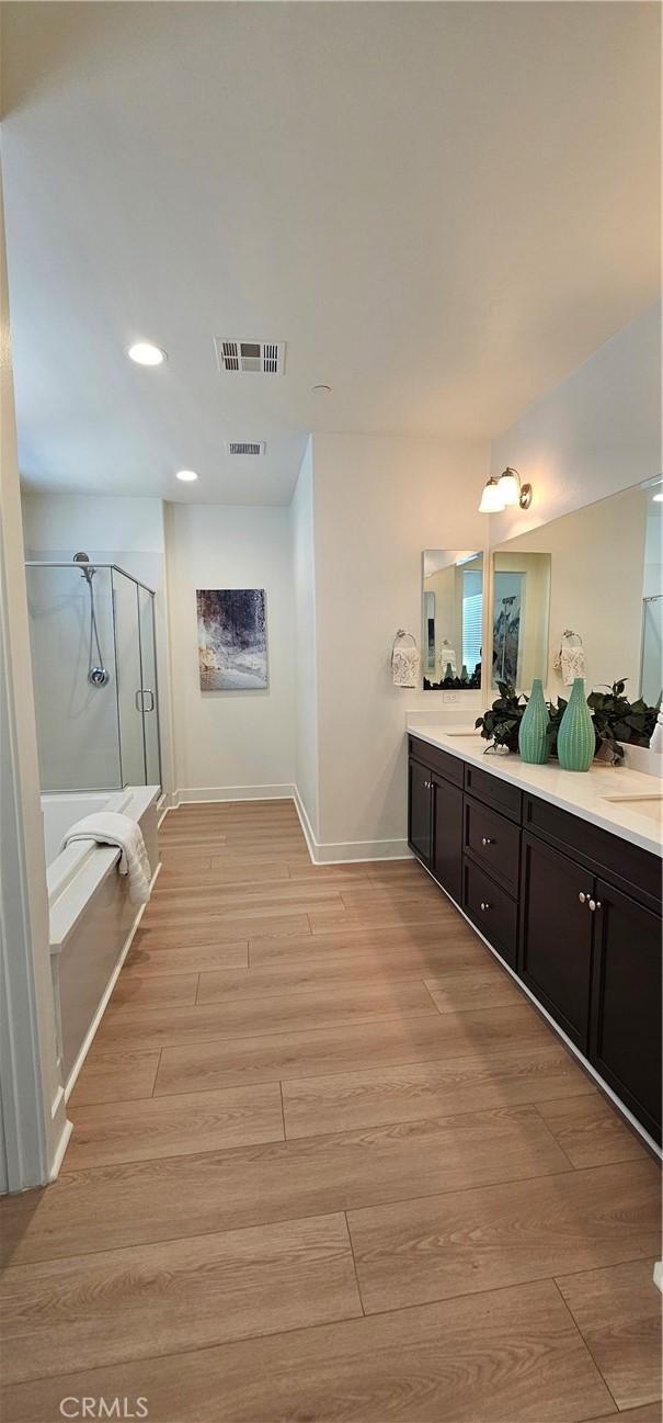 5232 Las Palmas Way, Chino, CA 91710 - full bath featuring a stall shower, double vanity, baseboards, wood finished floors, and recessed lighting