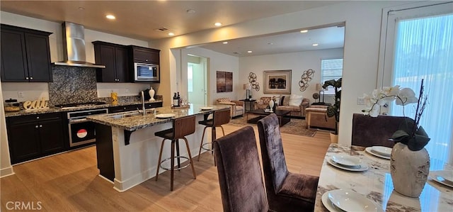 5232 Las Palmas Way, Chino, CA 91710 - kitchen featuring stainless steel appliances, a sink, wall chimney range hood, light wood-style flooring, and recessed lighting