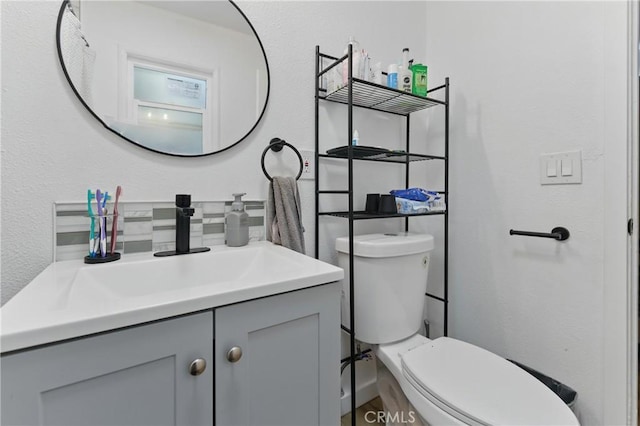 half bath featuring toilet and vanity