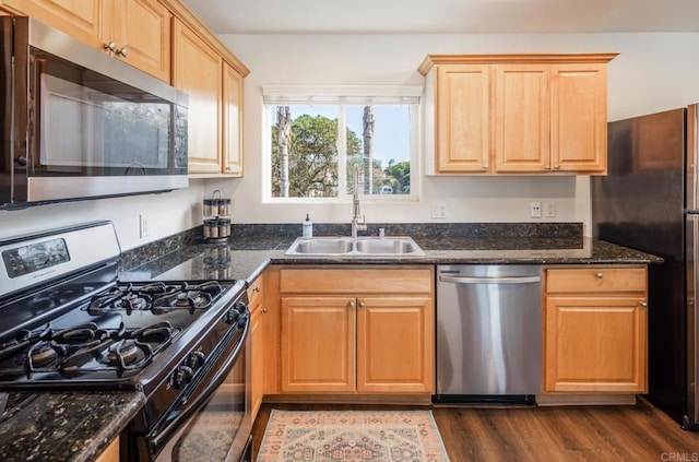 303305 Sanford St, Encinitas, CA 92024 - kitchen featuring stainless steel appliances, a sink, dark wood-type flooring, dark stone counters, and light brown cabinetry