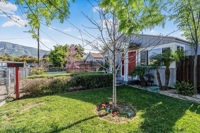 view of yard with a mountain view and fence