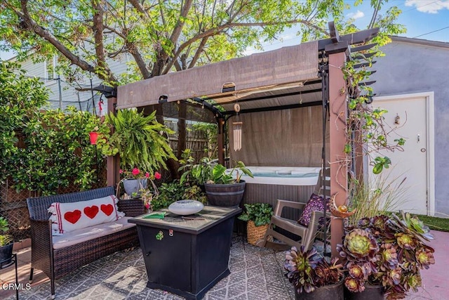 view of patio / terrace with a pergola, fence, and a hot tub
