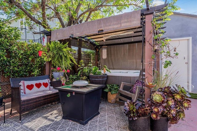 view of patio with a jacuzzi and fence