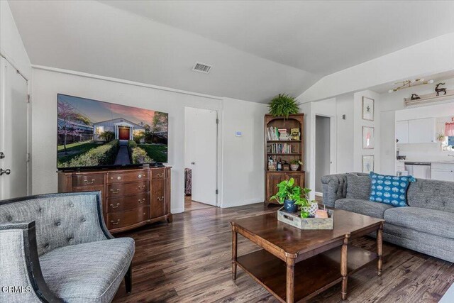 living room with visible vents, dark wood-style flooring, and vaulted ceiling