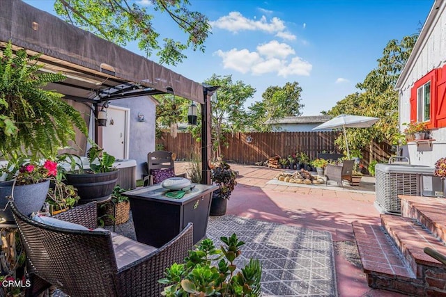 view of patio / terrace with a pergola, central air condition unit, and fence