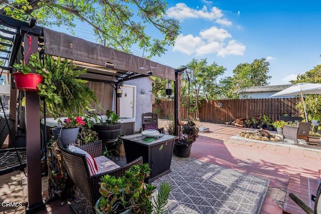 view of patio / terrace featuring a pergola and fence