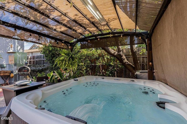 exterior space featuring fence and a hot tub
