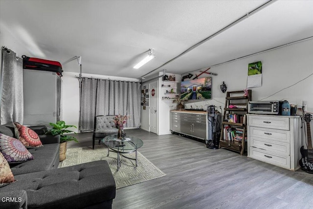 living area with a toaster and wood finished floors