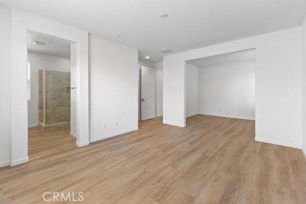 unfurnished bedroom with baseboards and light wood-type flooring