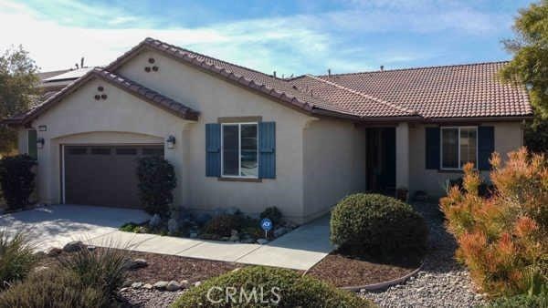 mediterranean / spanish house featuring stucco siding, an attached garage, a tiled roof, and concrete driveway