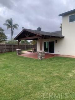 340 Foxenwood Dr, Santa Maria, CA 93455 - rear view of property with a patio, fence, and a lawn