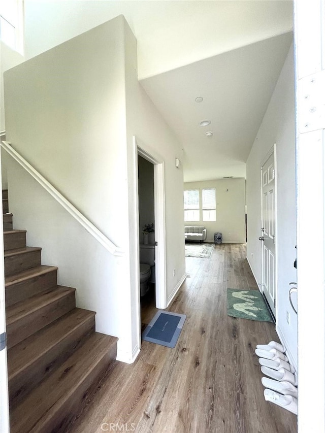 1406 Girona Dr, Pomona, CA 91766 - foyer entrance with wood finished floors, radiator heating unit, and stairway