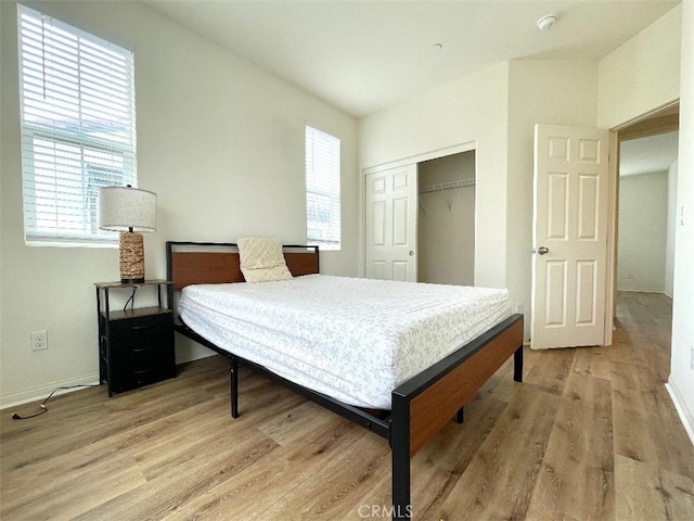 1406 Girona Dr, Pomona, CA 91766 - bedroom featuring a closet, baseboards, and light wood-style floors