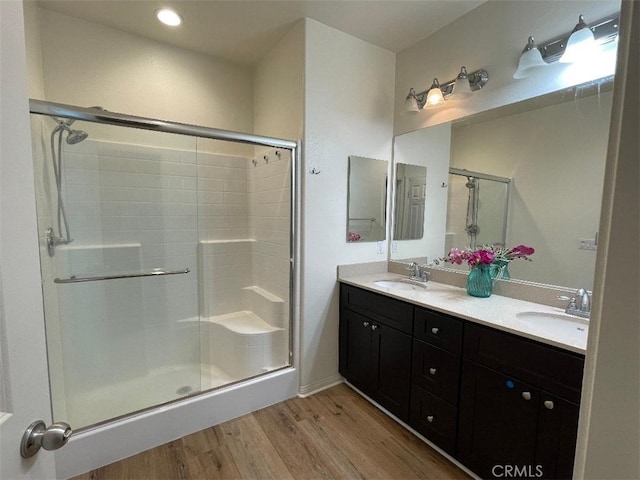 1406 Girona Dr, Pomona, CA 91766 - bathroom with a stall shower, double vanity, wood finished floors, and a sink
