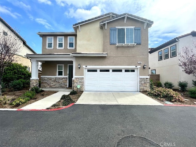 1406 Girona Dr, Pomona, CA 91766 - view of front of house with stucco siding, driveway, a garage, and stone siding