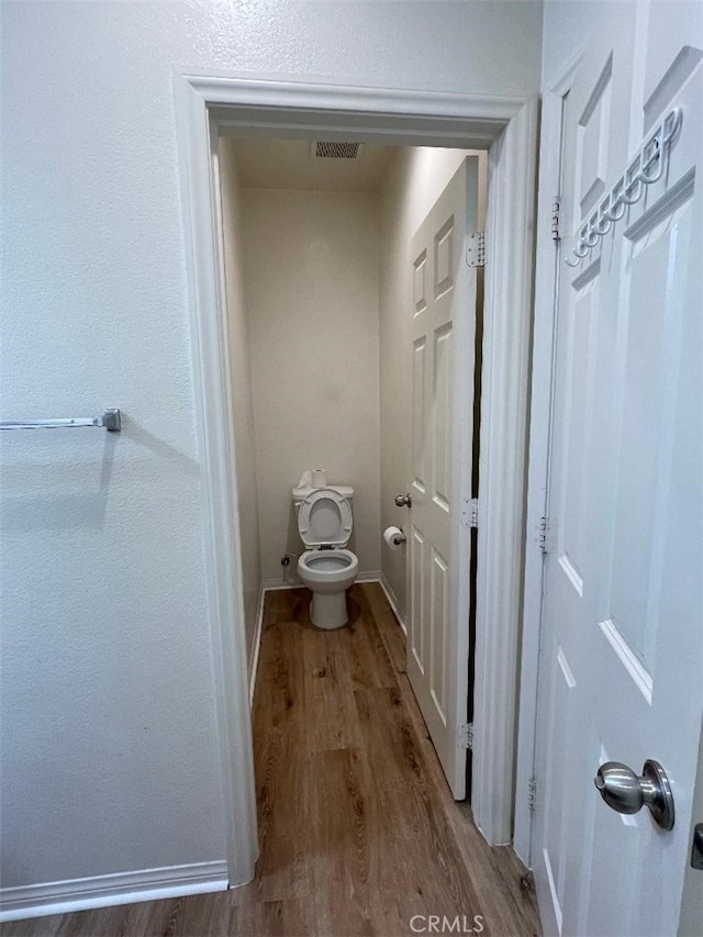1406 Girona Dr, Pomona, CA 91766 - bathroom with toilet, visible vents, wood finished floors, and baseboards