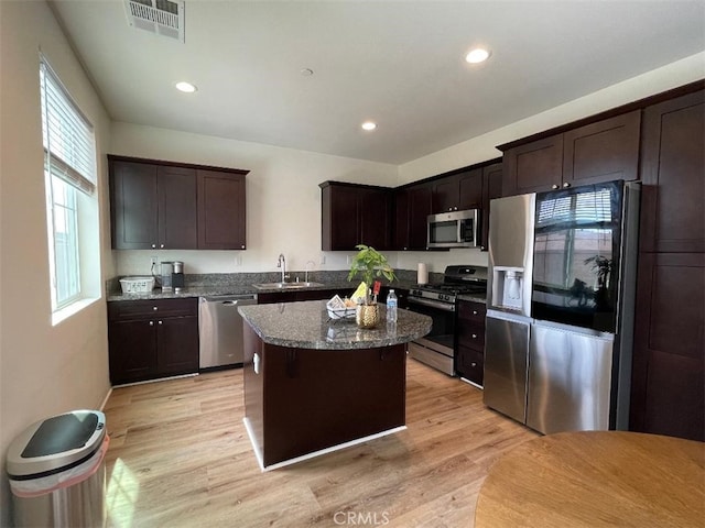 1406 Girona Dr, Pomona, CA 91766 - kitchen featuring dark brown cabinetry, a sink, appliances with stainless steel finishes, light wood-type flooring, and visible vents