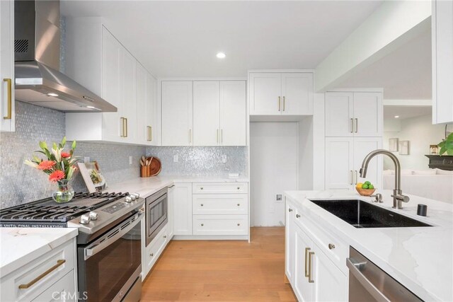 2902 Ladoga Ave, Long Beach, CA 90815 - kitchen featuring wall chimney range hood, appliances with stainless steel finishes, a sink, light stone counters, and recessed lighting