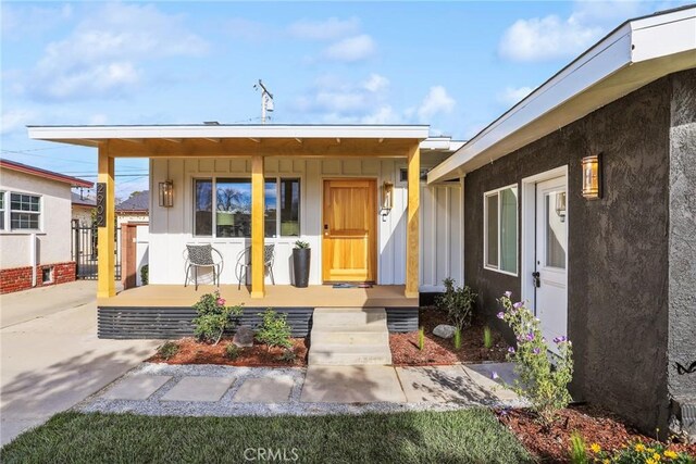 2902 Ladoga Ave, Long Beach, CA 90815 - property entrance with a porch and board and batten siding