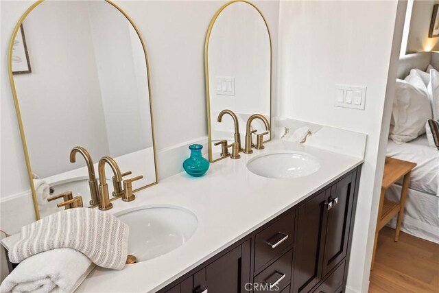 2902 Ladoga Ave, Long Beach, CA 90815 - ensuite bathroom featuring double vanity and wood finished floors