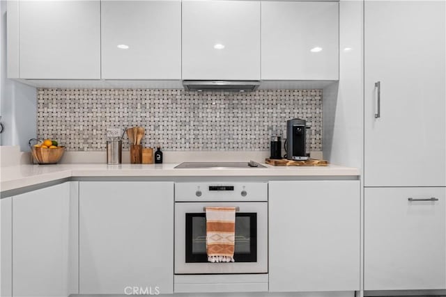 2233 Martin Unit 212, Irvine, CA 92612 - kitchen with white oven, modern cabinets, white cabinetry, and black electric stovetop