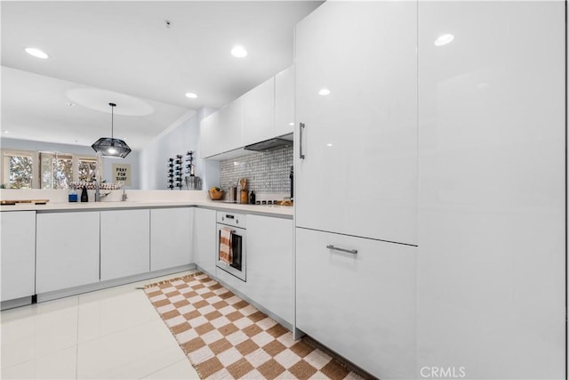 2233 Martin Unit 212, Irvine, CA 92612 - kitchen featuring oven, white cabinets, light countertops, hanging light fixtures, and recessed lighting