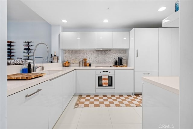 2233 Martin Unit 212, Irvine, CA 92612 - kitchen with white cabinetry, a sink, modern cabinets, and white oven