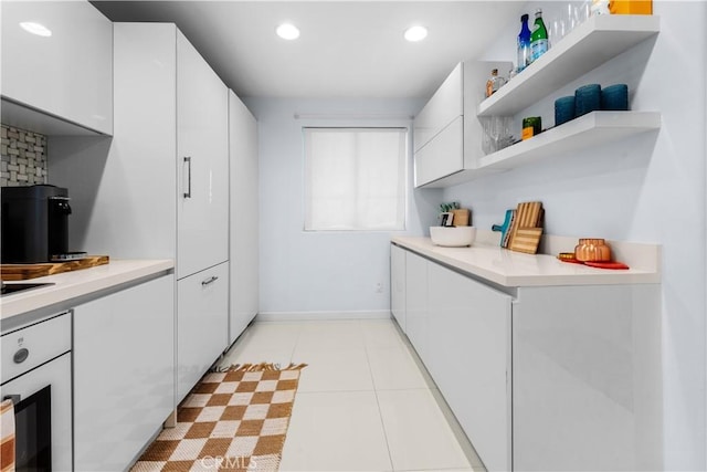 2233 Martin Unit 212, Irvine, CA 92612 - kitchen with open shelves, wall oven, white cabinets, and light countertops