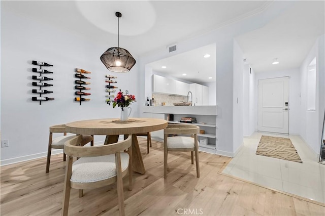 2233 Martin Unit 212, Irvine, CA 92612 - dining space featuring baseboards, light wood-style flooring, and visible vents