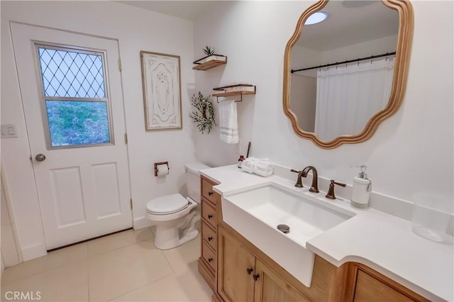 bathroom with toilet, tile patterned flooring, vanity, and a shower with curtain