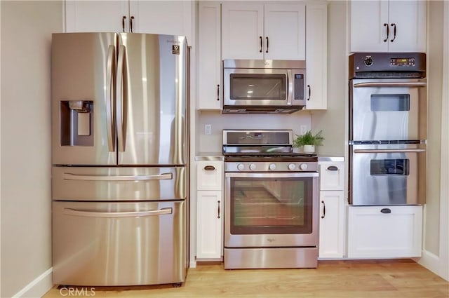 kitchen featuring white cabinetry, light wood-style floors, and stainless steel appliances
