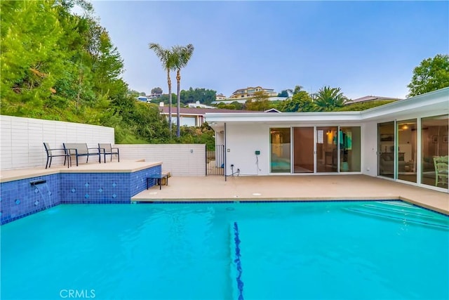 view of pool featuring a patio area, fence, and a fenced in pool