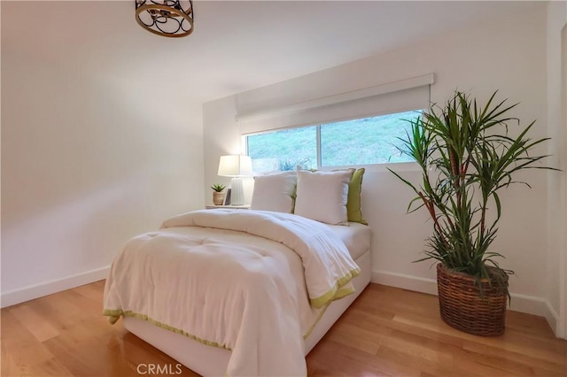 bedroom featuring light wood-style flooring and baseboards
