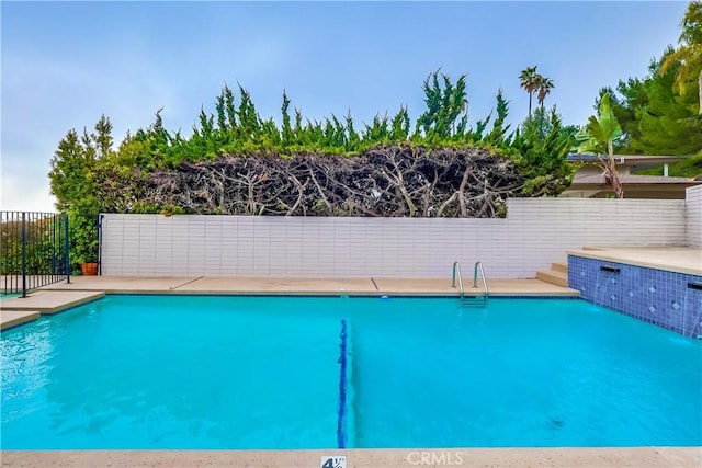 view of swimming pool with fence and a fenced in pool