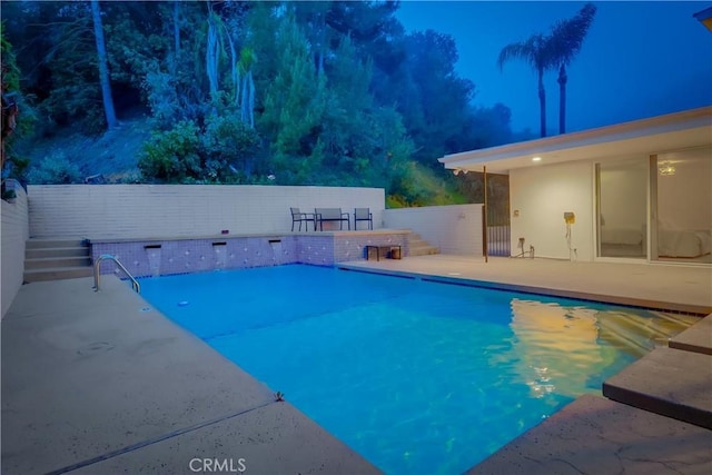 view of swimming pool featuring a patio area, a fenced in pool, and fence